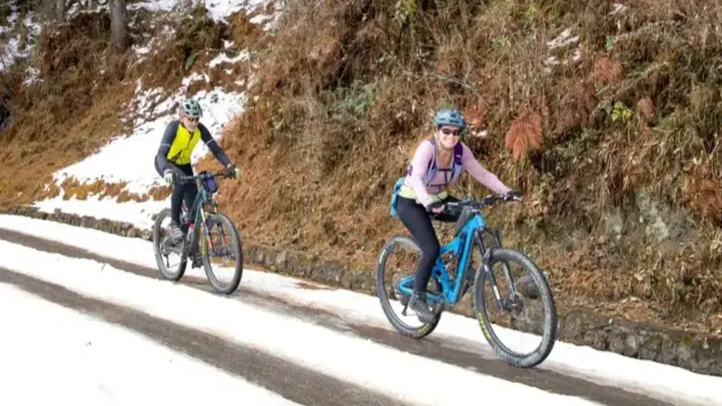 Guests cyling on the snowy roads of Bhutan