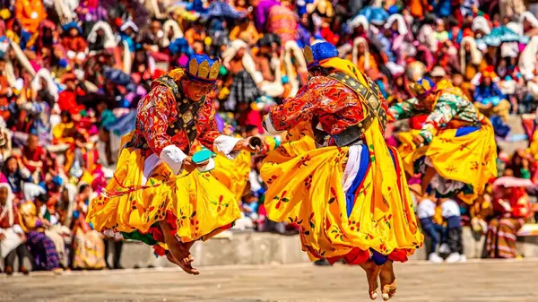 Crowds and mask dancers during the five-day Paro Tshechu program at Rinpung Dzong