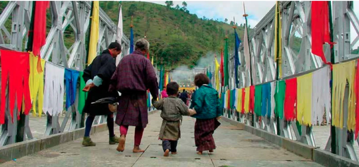 No Traffic Light in the entire country of Bhutan - bhutanese family walking on a newly constructed road large