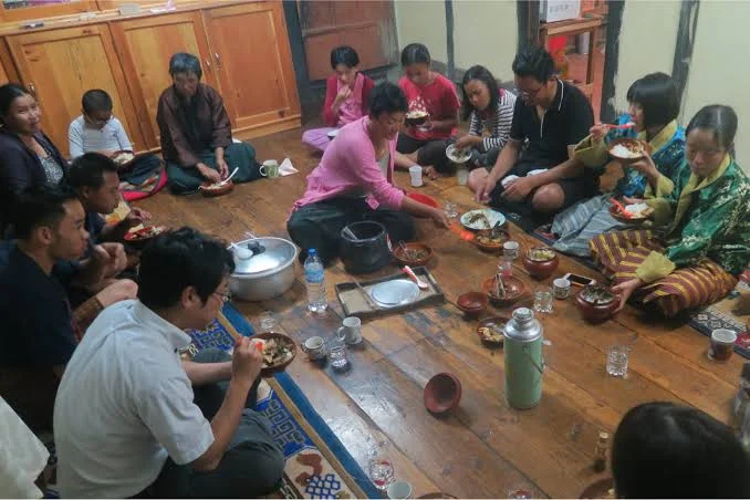 A Toast to Bhutan: Traditional Alcohol, Local Drinks & the Stories Behind Them - bhutanese enjoying alcohol during meal large