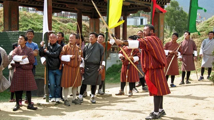 Archery in Bhutan: The National Sport Explained - men playing traditional archery in bhutan large